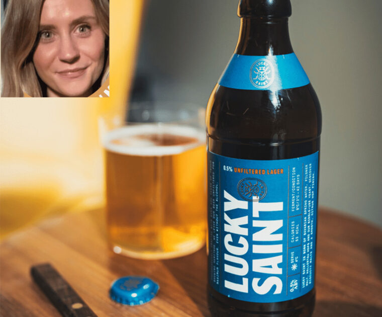 Lucky Saint beer bottle and glass, with a photo of Emily Laws